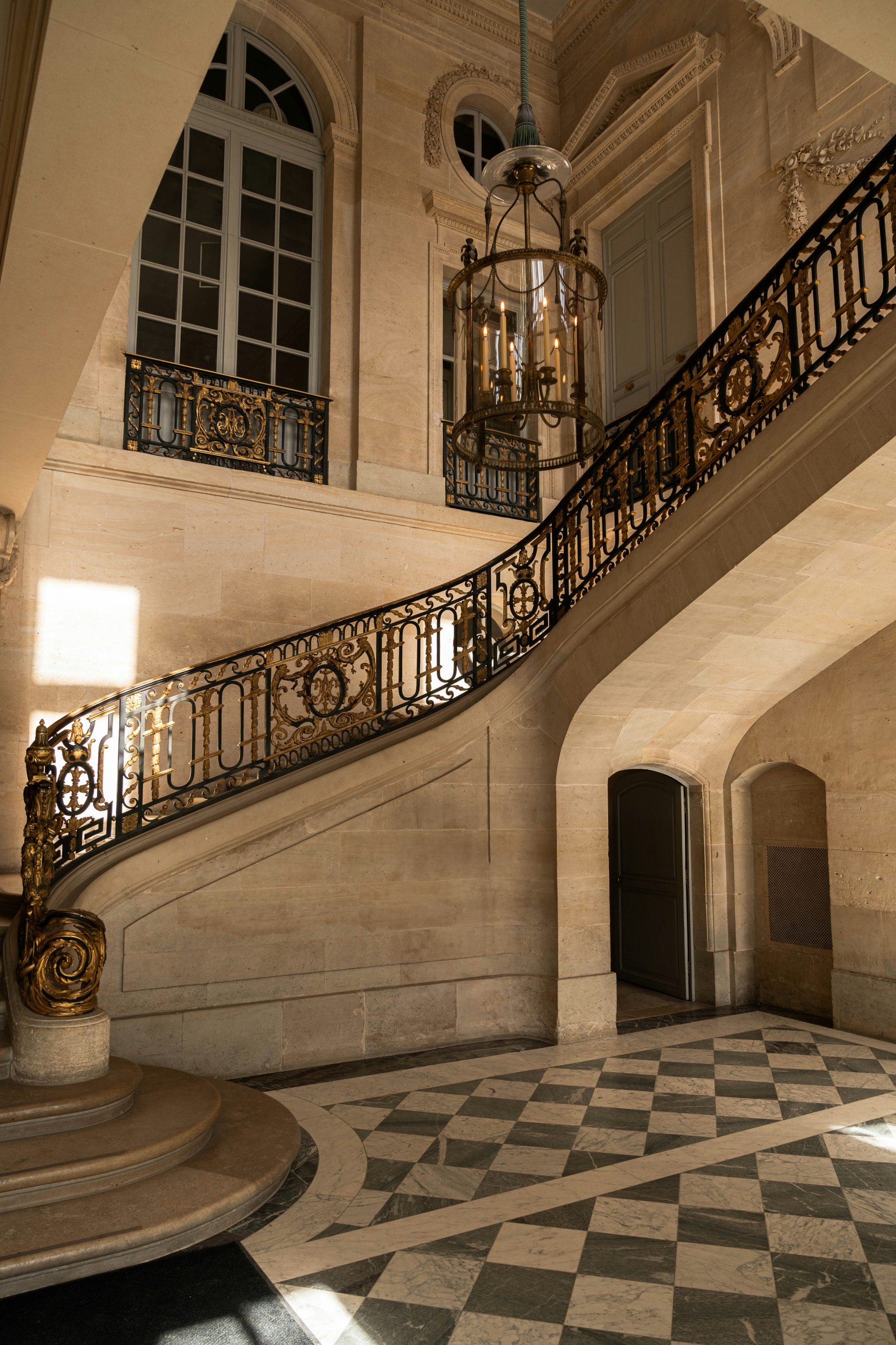 A staircase in a building with a checkered floor